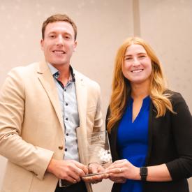 Nathan Coffill presents award to Laura DeMerchant